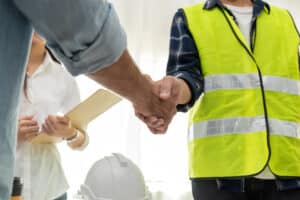 construction worker partner handshake